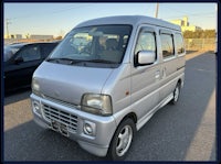 a silver van is parked in a parking lot