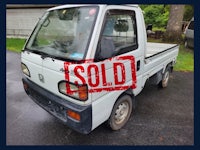 a white truck with a sold sign on it