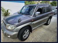 a silver suv parked in front of a building